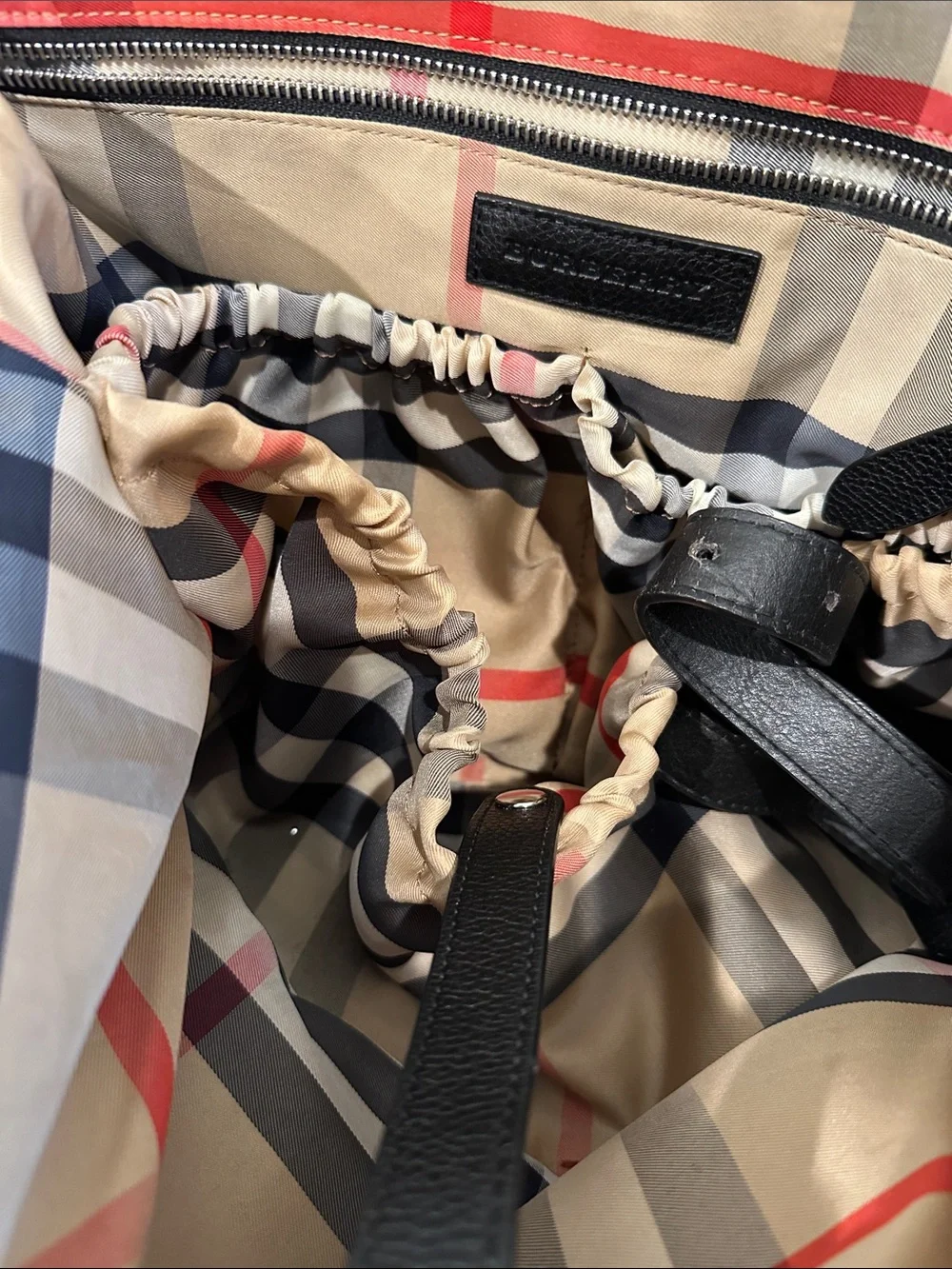 Burberry diaper bag. Black nylon with signature Burberry print inside.